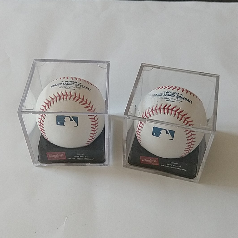 2 Rawlings official balls with plastic case